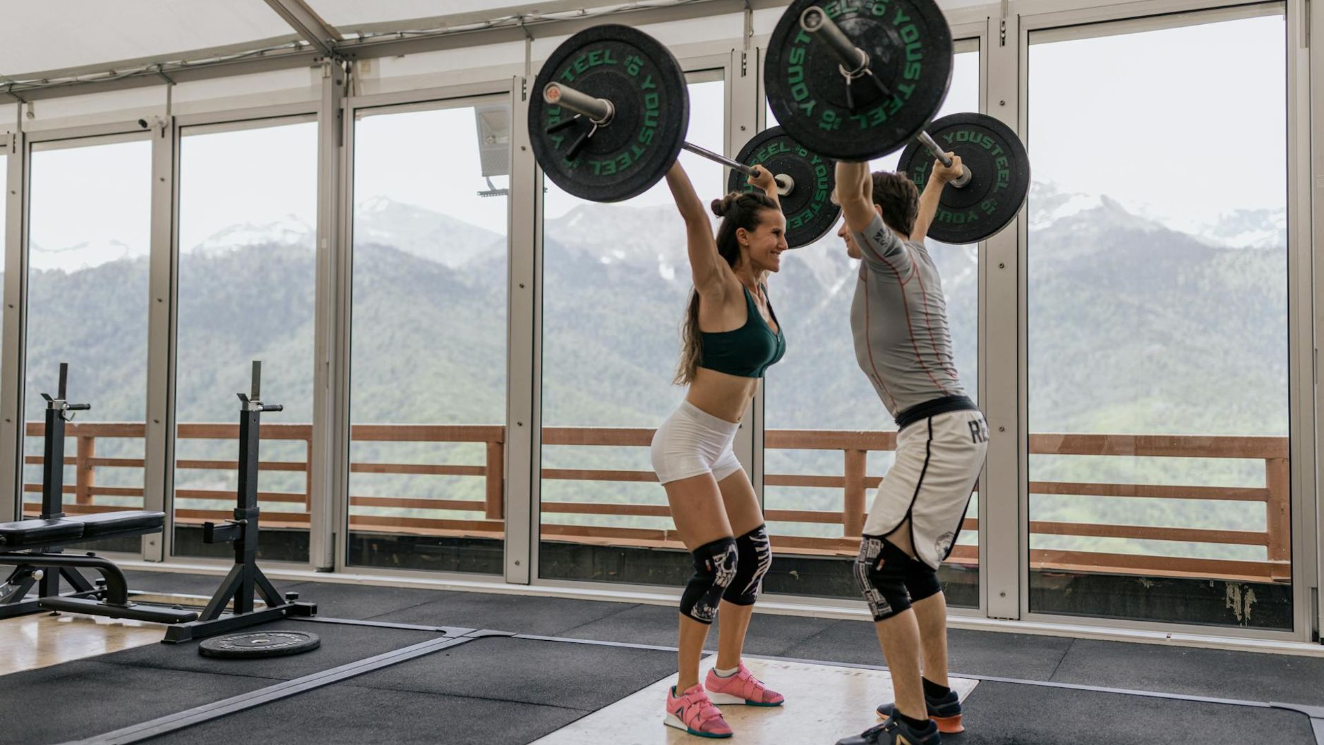 Strong man focused on heavy training session in a dark gym